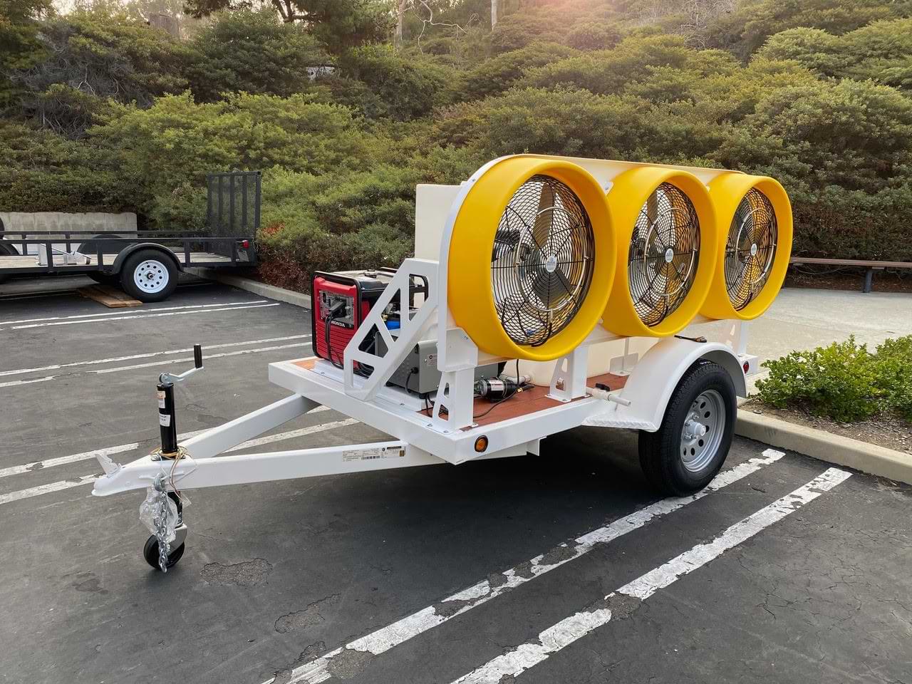 Misting trailer with yellow fans