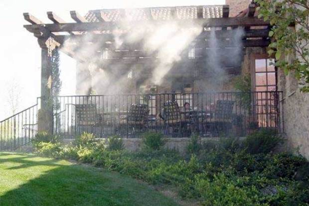 Backyard cooled by a patio misting system